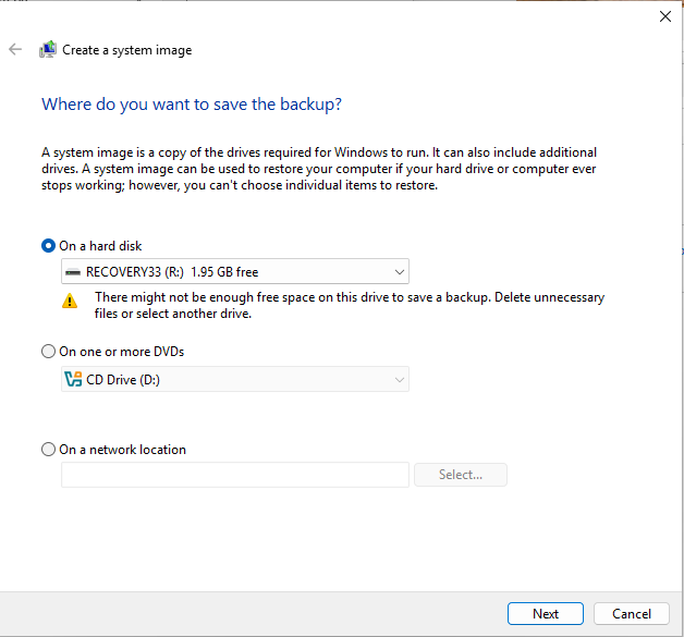 Complete legacy Create a system image destination dialog. It lists a hard disk, DVDs or a network location. The displayed RECOVERY33 (R:) has 1.95GB free, and Windows warns there might not be enough free space. Next and Cancel are visible.